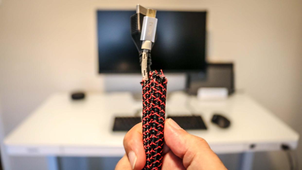  Wires wrapped in a cable sleeve in front of a desk 