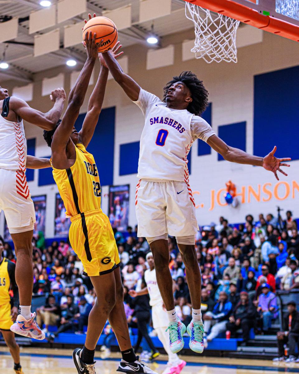 Johnson's Joshua Quarterman attempts to follow through with the basket despite the Groves defender at Johnson High School on February 9, 2024.