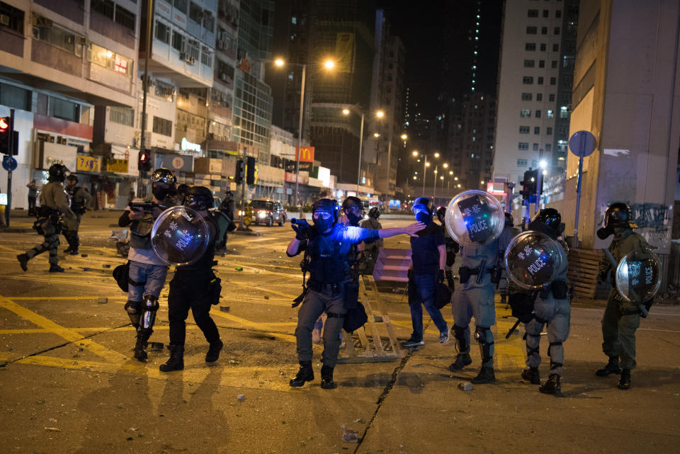 HONG KONG, CHINA - 2019/11/14: Police stand-off with protesters outside Mong Kok police station. The protest movement has seen a spike in violence since the death of university student Alex Chow on November 9, after falling from the ledge of a car park while reportedly fleeing tear gas fired by police. Despite the controversial extradition bill which originally sparked the protests being formally withdrawn, protesters continue to call on Chief Executive Carrie Lam to meet their remaining demands, which includes complete universal suffrage, an independent investigation into police brutality, retraction of the word rioting to describe the protests, and dropping all charges against arrested protesters. (Photo by Oliver Haynes/SOPA Images/LightRocket via Getty Images)