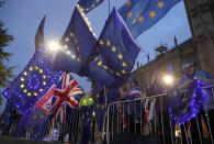 Pro EU protestors wave flags opposite parliament in London, Monday, Sept. 9, 2019. British Prime Minister Boris Johnson voiced optimism Monday that a new Brexit deal can be reached so Britain leaves the European Union by Oct. 31.(AP Photo/Frank Augstein)