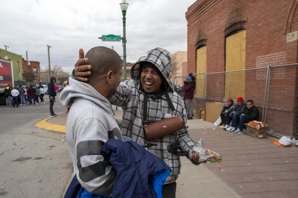 Two migrants, who met earlier on their way to the U.S., celebrate after seeing each other in downtown El Paso, Texas, Sunday, Dec. 18, 2022. Texas border cities were preparing Sunday for a surge of as many as 5,000 new migrants a day across the U.S.-Mexico border as pandemic-era immigration restrictions expire this week, setting in motion plans for providing emergency housing, food and other essentials. (AP Photo/Andres Leighton)