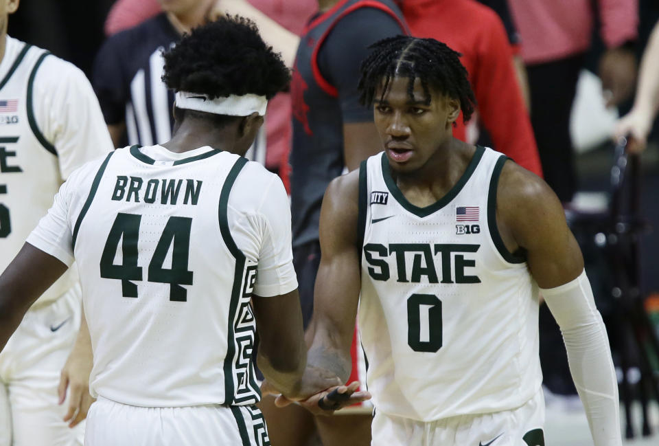 Michigan State forward Aaron Henry (0) celebrates with forward Gabe Brown (44) after scoring against Ohio State during the second half of an NCAA college basketball game Thursday, Feb. 25, 2021, in East Lansing, Mich. (AP Photo/Duane Burleson)