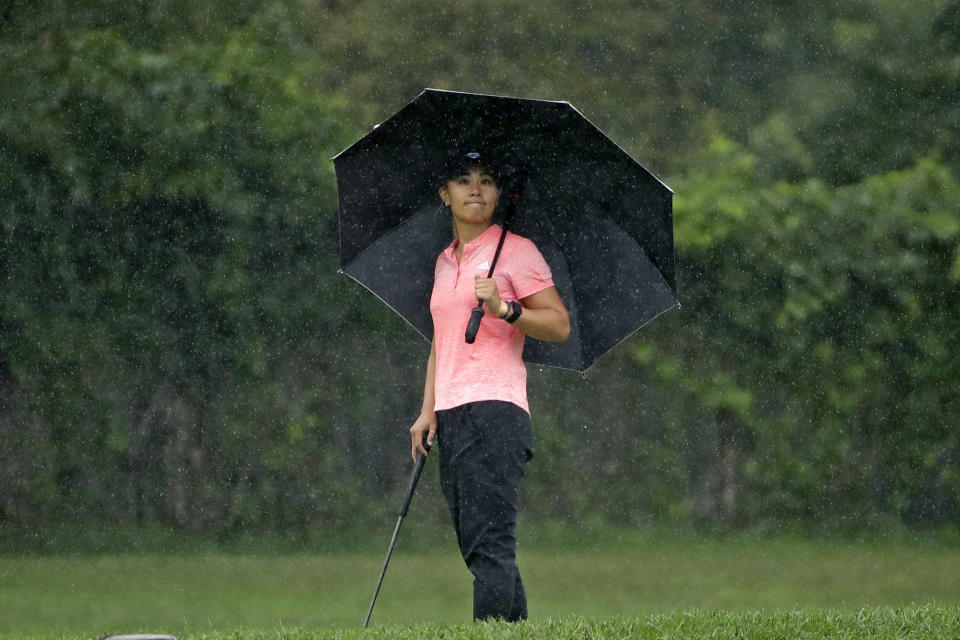 CORRECTS SPELLING OF FIRST NAME TO DANIELLE, N0T DANNIELLE - Danielle Kang stands under an umbrella while waiting to putt on the eighth hole during the second round of the LPGA Drive On Championship golf tournament Saturday, Aug. 1, 2020 at Inverness Golf Club in Toledo, Ohio. (AP Photo/Gene J. Puskar)