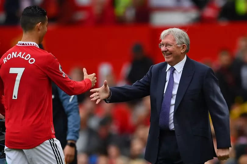 Cristiano Ronaldo of Manchester United is presented with an award for scoring 700 goals by Ex Manchester United Manager Sir Alex Ferguson prior tod the Premier League match between Manchester United and Newcastle United at Old Trafford on October 16, 2022 in Manchester, England.