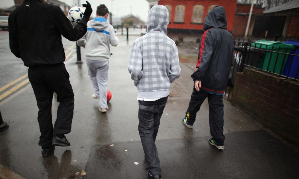 teenagers on poor-looking street