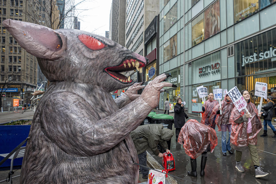 A giant inflatable rat stands opposite the Daily News headquarters as its employees protest, Thursday, Jan. 25, 2024, in New York. (AP Photo/Peter K. Afriyie)