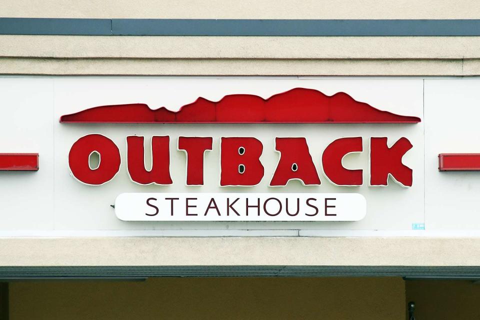 <p>Bruce Bennett/Getty</p> An Outback Steakhouse sign