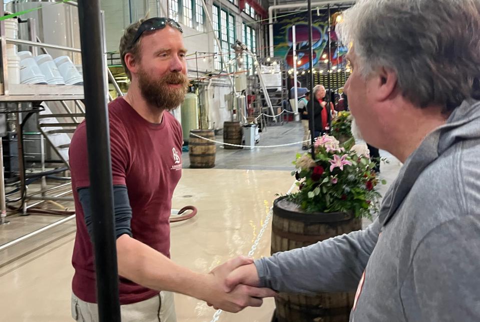Ron Shea, co-founder of R. Shea Brewing Co., shakes hands with customers and takes notes on ways to improve his 60-day campaign to raise $2.3 million to save his brewery.