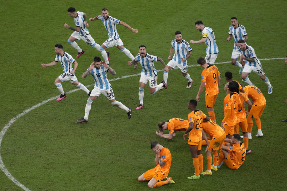 Argentina players celebrate at the end of the World Cup quarterfinal soccer match between the Netherlands and Argentina, at the Lusail Stadium in Lusail, Qatar, Saturday, Dec. 10, 2022. (AP Photo/Thanassis Stavrakis)