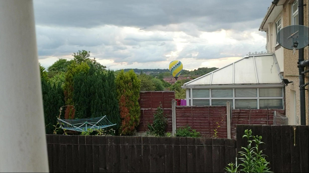 The yellow and blue balloon had to suddenly land due to strong winds. (SWNS)