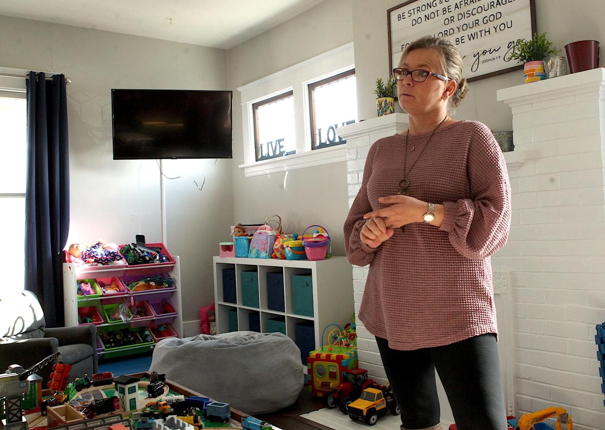 Kelsi Sullivan discusses the formation of the Agape House in the house's living room Tuesday afternoon. Sullivan is president of the Agape House board.