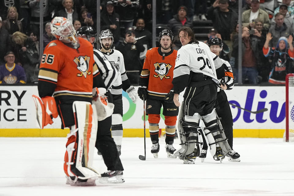 Los Angeles Kings goaltender Pheonix Copley, second from right, is held back by referee Ian Walsh, right, after Anaheim Ducks goaltender John Gibson crossed center ice during a fight in the second period of an NHL hockey game Friday, Feb. 17, 2023, in Anaheim, Calif. Copley was tossed from the game with a match penalty. (AP Photo/Mark J. Terrill)