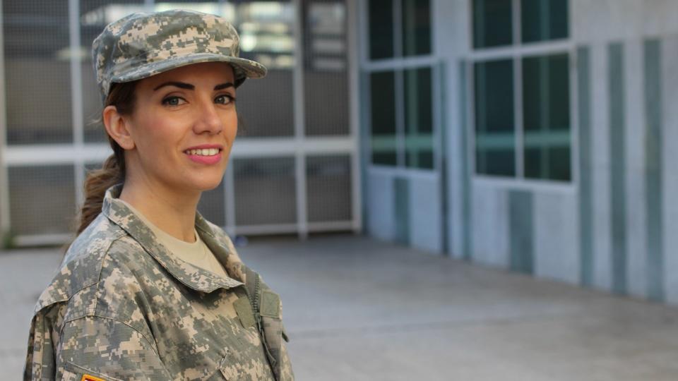 Military female smiling - Stock image with copy space.