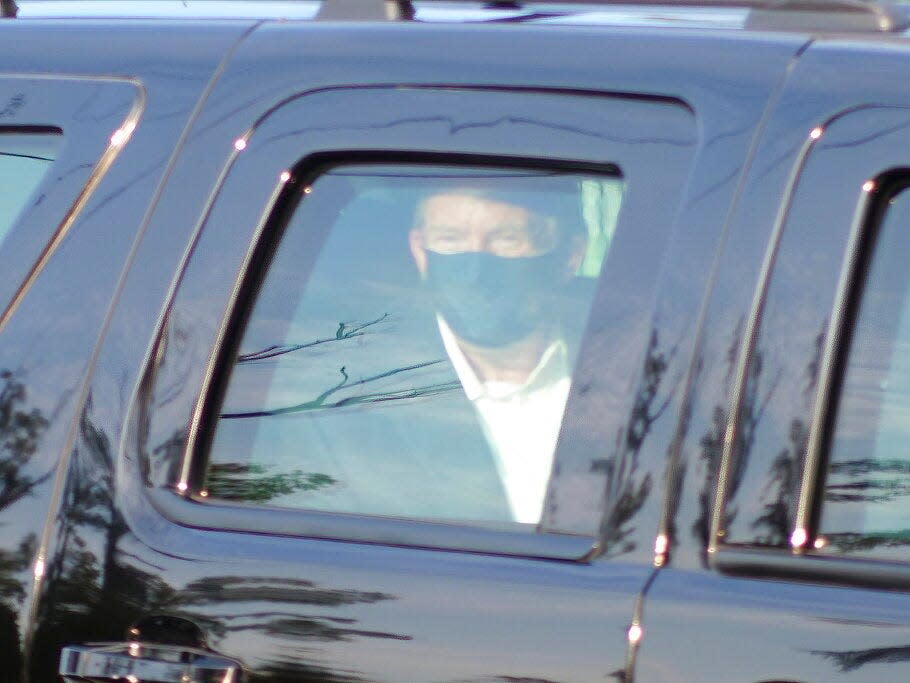 President Donald Trump drives past supporters gathered outside Walter Reed National Military Medical Center in Bethesda, Md., Sunday, Oct. 4, 2020.