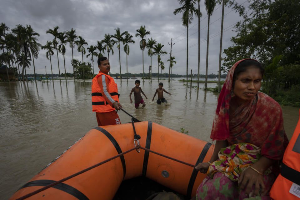 National Disaster Response Force (NDRF) personnel rescue flood-affected villagers in Korora village, west of Gauhati, India, Friday, June 17, 2022. (AP Photo/Anupam Nath)