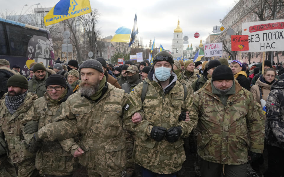 War veterans and supporters of former Ukrainian President Petro Poroshenko gather near a court building in Kyiv, Ukraine, Wednesday, Jan. 19, 2022. A Kyiv court is due to rule on whether to remand Poroshenko in custody pending investigation and trial on treason charges he believes are politically motivated. (AP Photo/Efrem Lukatsky)