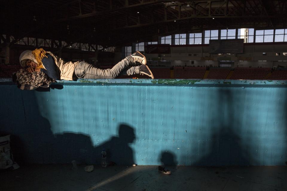 A Central American migrant who is traveling with a caravan hoping to reach the U.S. border, rests before leaving the Benito Juarez Auditorium that sheltered the migrants overnight in Guadalajara, Mexico, early Tuesday, Nov. 13, 2018. Many migrants say they are fleeing rampant poverty, gang violence and political instability primarily in the Central American countries of Honduras, Guatemala, El Salvador and Nicaragua. (AP Photo/Rodrigo Abd)