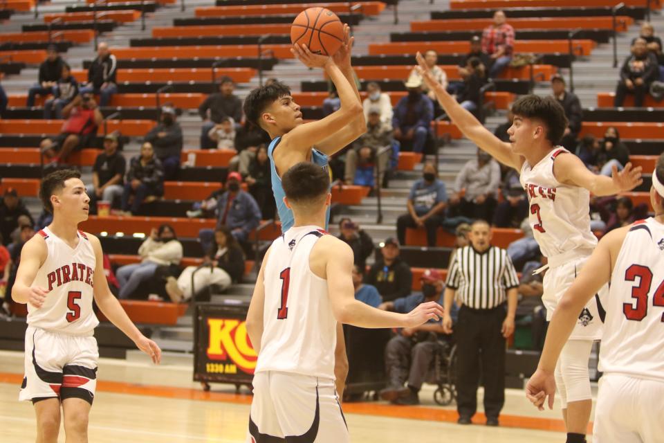Navajo Prep's Xavier Nez puts up a shot over the outstretched arm of Grants' Boudy Melonas during the second quarter of a first round game of the Gallup High Boys Basketball Invitational Tournament, Thursday, Jan. 5, 2023 at Gallup High.