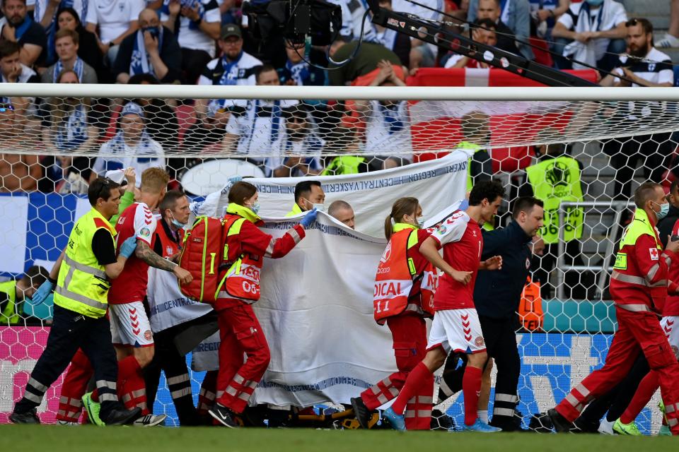 Denmark’s Christian Eriksen is taken away on a stretcher after collapsing on the pitch (Reuters)