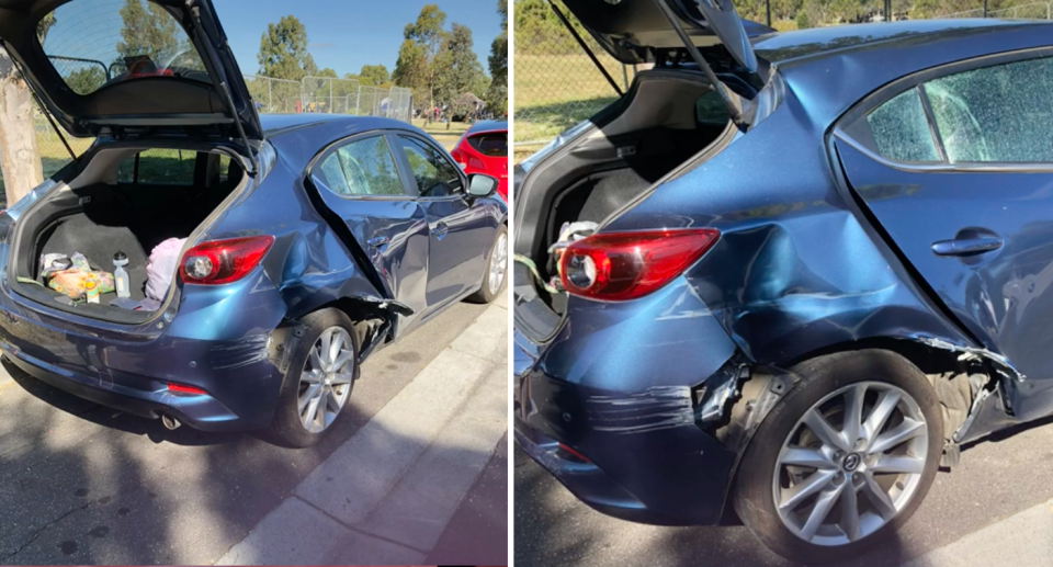 The blue Mazda 2 has large dents on the side of the car and the window is broken. 