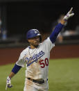 Los Angeles Dodgers' Mookie Betts celebrates a home run against the Tampa Bay Rays during the sixth inning in Game 1 of the baseball World Series Tuesday, Oct. 20, 2020, in Arlington, Texas. (AP Photo/Eric Gay)