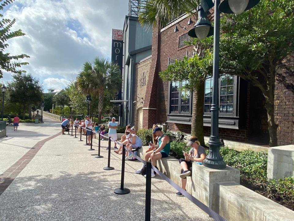 People wait in line to visit Gideon's Bakehouse at Disney Springs.