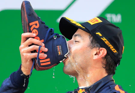 FILE PHOTO: Red Bull's Daniel Ricciardo drinks from a shoe as he celebrates winning the Formula One Chinese Grand Prix at Shanghai International Circuit, Shanghai, China.REUTERS/Aly Song