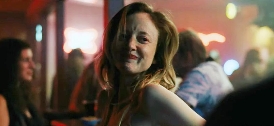 Andrea Riseborough smiles at a bar