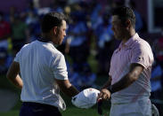 Xander Schauffele of United States, left, shakes hand with Hideki Matsuyama of Japan at the end of the third round of the men's golf event at the 2020 Summer Olympics on Saturday, July 31, 2021, in Kawagoe, Japan. (AP Photo/Matt York)