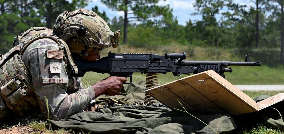 Senior Airman Kevontrae Holley, a 908th Security Forces Squadron defender, fires an M240B machine gun Aug. 6, 2022, at Fort Rucker, Alabama. This firearm is a belt-fed, gas-operated medium machine gun that chambers the 7.62 mm NATO cartridge, and is operated by a gunner and an assistant gunner.