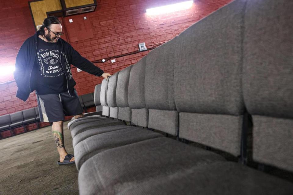 Chaz Buchannan, one of the owners of the Haltom Theater, sets up seating chairs for a live performance later in the day at his theater in Haltom City, Texas on Saturday, July 29, 2023.