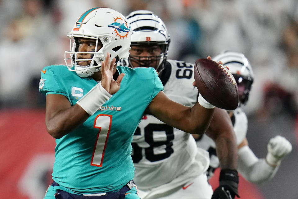 Sep 29, 2022; Cincinnati, Ohio, USA; Miami Dolphins quarterback Tua Tagovailoa (1) is pursued by Cincinnati Bengals defensive tackle Josh Tupou (68) in the second quarter against the Cincinnati Bengals at Paycor Stadium. Mandatory Credit: Sam Greene/Cincinnati Enquirer via USA TODAY NETWORK