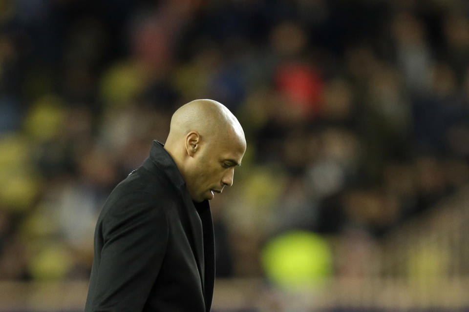 Monaco coach Thierry Henry walks out the pitch at half time during the Champions League group A soccer match between AS Monaco and Borussia Dortmund, in Monaco, Tuesday, Dec. 11, 2018. (AP Photo/Claude Paris)