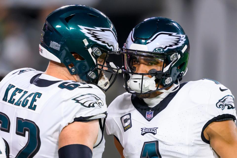 Philadelphia Eagles center Jason Kelce (62) and quarterback Jalen Hurts (1) talk on the field before taking on the Tampa Bay Buccaneers during an NFL wild-card playoff football game, Monday, Jan. 15, 2024 in Tampa, Fla.