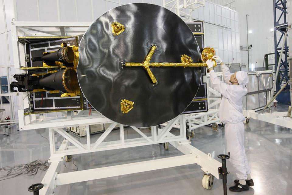 An engineer works on an antenna for the Express AM8 satellite in Zheleznogorsk