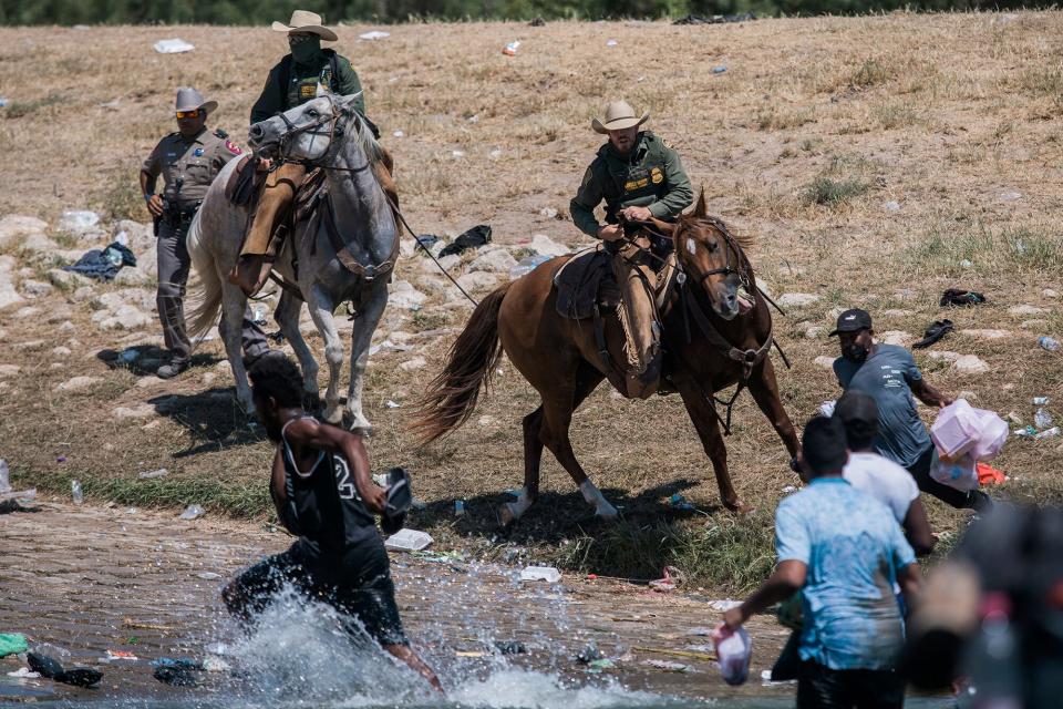 Customs and Border Protection mounted officers attempt to contain mostly migrants as they cross the Rio Grande from Ciudad AcuÒa into Del Rio, Texas, . Thousands of Haitian migrants have been