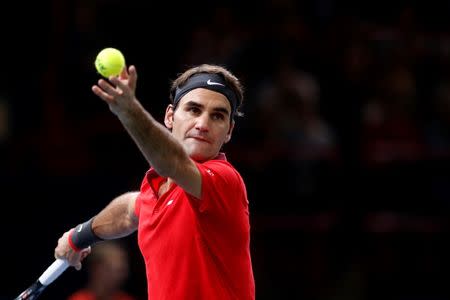 Switzerland's Roger Federer serves the ball during his men's singles tennis match against Lucas Pouille of France in the third round of the Paris Masters tennis tournament at the Bercy sports hall in Paris, October 30, 2014. REUTERS/Benoit Tessier