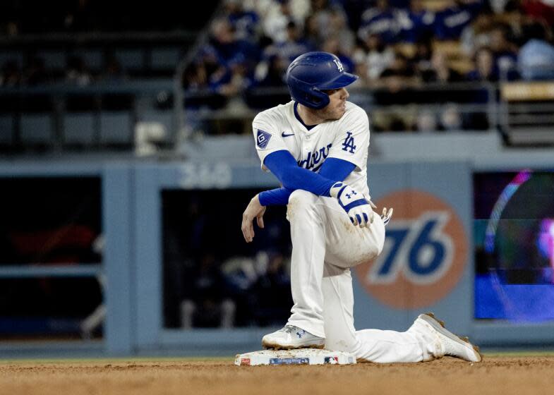 LOS ANGELES, CA - APRIL 1, 2024: Los Angeles Dodgers first baseman Freddie Freeman (5) kneels at second base during a play review after hitting an RBI double against the San Francisco Giants in the seventh inning at Dodger Stadium on April 1, 2024 in Los Angeles, California. (Gina Ferazzi / Los Angeles Times)