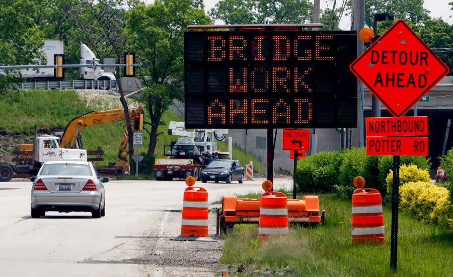 Signs direct traffic at a construction site along Interstate 294 (I-294) near Chicago. (File Photo by Frank Polich /Bloomberg via Getty Images)