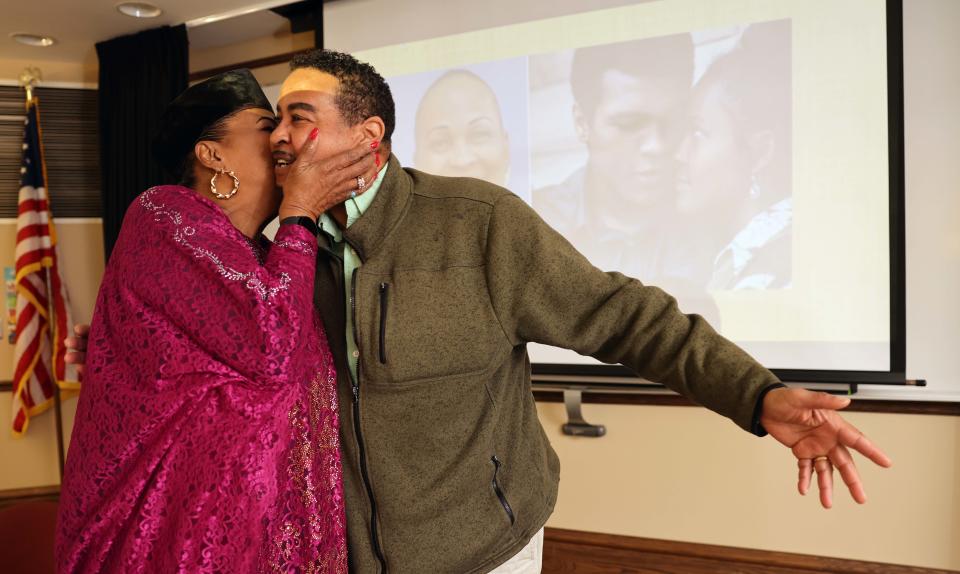 Nathan Raines of Cambridge gets a kiss from his cousin Khalilah Camacho-Ali, Muhammad Ali's ex-wife, who visited the Brockton Public Library on Saturday, March 4, 2023.