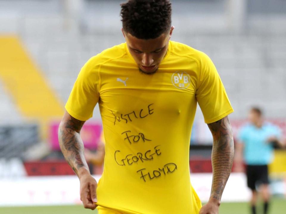 Jadon Sancho celebrates his goal by revealing a 'Justice for George Floyd' on his undershirt: Reuters