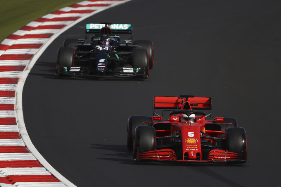 Ferrari driver Sebastian Vettel of Germany steers his car followed by Mercedes driver Lewis Hamilton of Britain during qualification for the Eifel Formula One Grand Prix at the Nuerburgring racetrack in Nuerburg, Germany, Saturday, Oct. 10, 2020. The Germany F1 Grand Prix will be held on Sunday. (Bryn Lennon, Pool via AP)