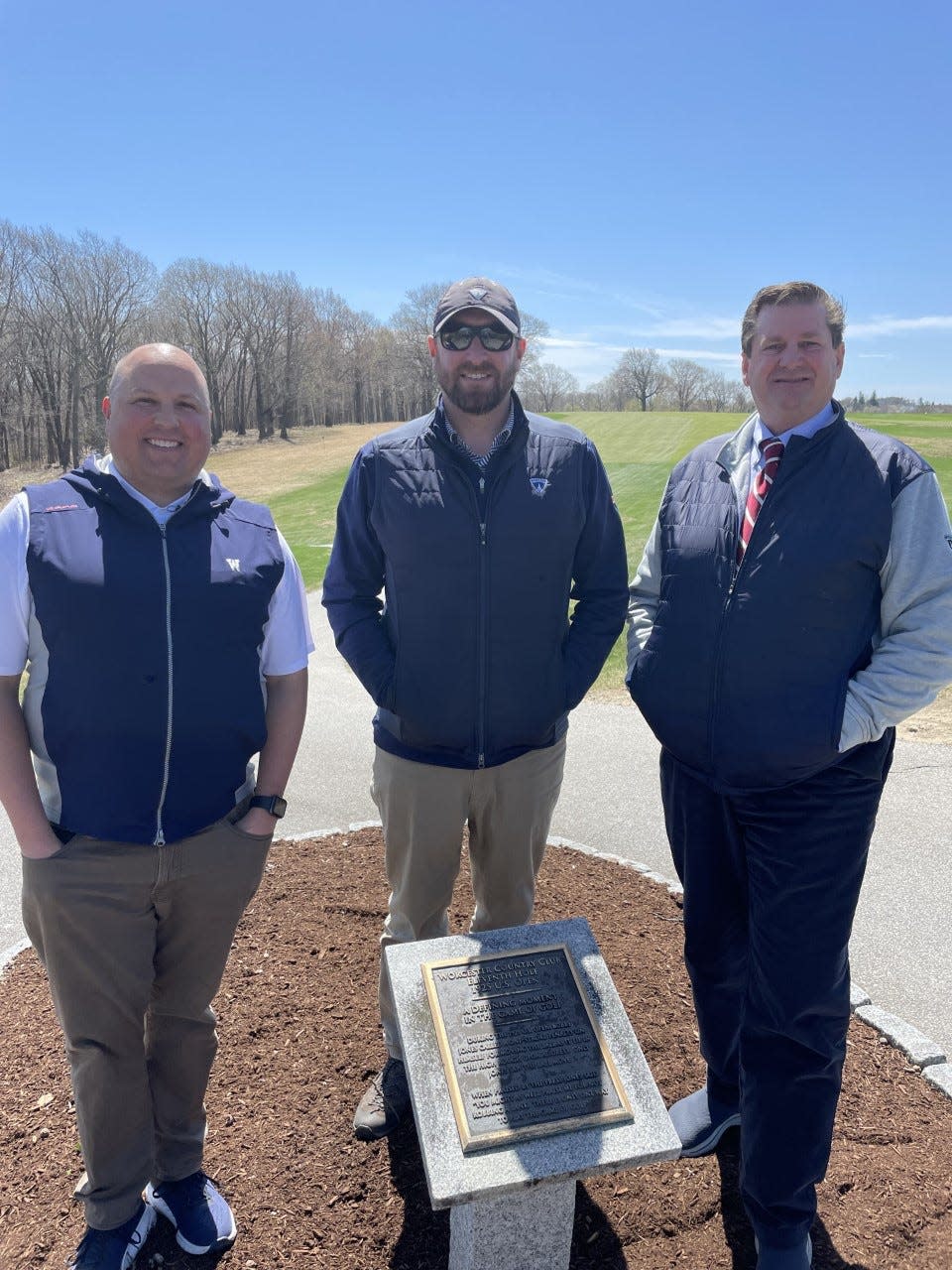 From left, Worcester Country Club head pro Andy Lane, superintendent Adam Moore and general manager Troy Sprister stand behind a plaque on the 11th tee commemorating Bobby Jones calling a penalty stroke on himself in the 1925 U.S. Open.