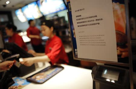 A sign at a McDonald's branch alerts costumers that there is only a limited menu available after a tainted food scandal involving Chinese supplier Husi Food Co Ltd, in Shanghai July 28, 2014. REUTERS/Carlos Barria