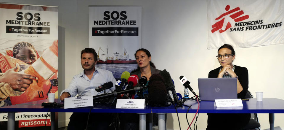 Sophie Beau, center, general director of SOS Mediterranee France, Frederic Penard, operations director for SOS Mediterranee, left, and Hassiba Hadj Sahraoui, from Doctors without Borders group, answer reporters Tuesday, Aug.14, 2018 in Paris. Portugal has become the first European country to say it could take in some migrants aboard rescue ship Aquarius, operated by French groups, as officials in coastal France made impassioned pleas to a so-far-silent French government to allow its docking. (AP Photo/Michel Spingler)