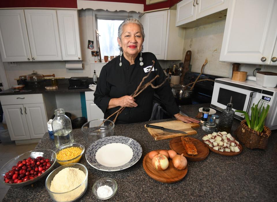 Sherry Pocknett, USA Today Connecticut Woman of the Year and James Beard Foundation award recipient, prepares smoked salmon hash with poached eggs and corn cakes at her Preston home Friday January 12, 2024. She holds sassafrass roots to make sassafrass tea.