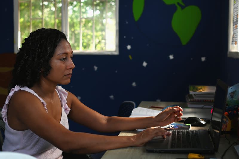 Claudia Patricia Fortich, widow of late oil tanker captain Jaime Herrera Orozco who was murdered on his ship while anchored off Venezuela, uses her computer to search for a job, at her home in Cartagena