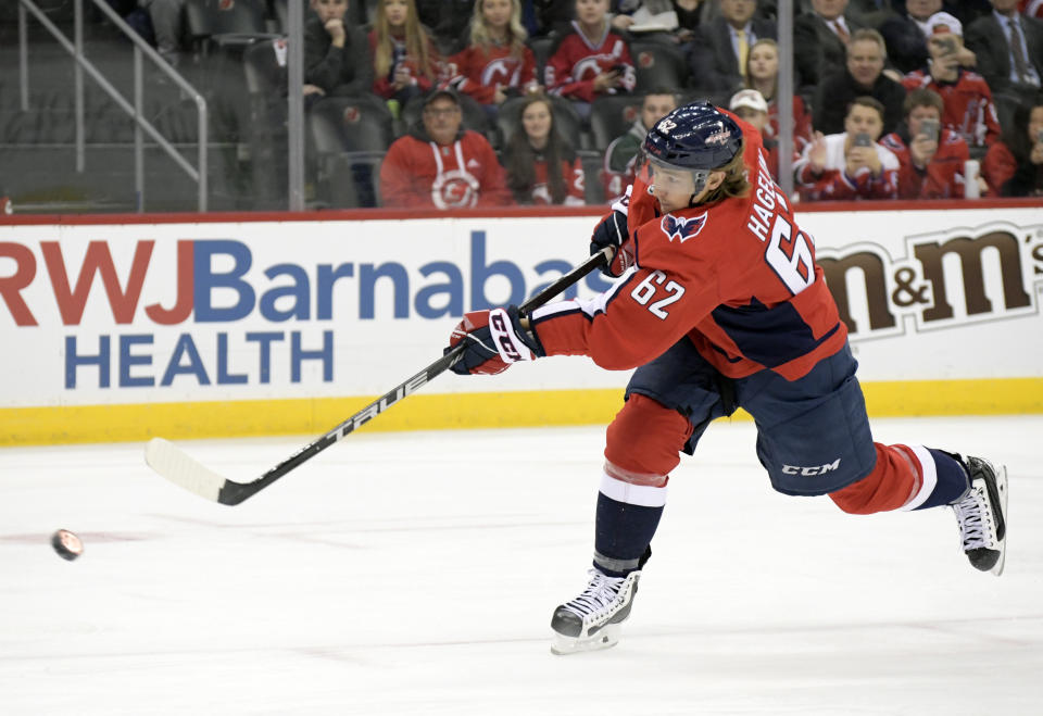 Washington Capitals left wing Carl Hagelin (62) takes a penalty shot against New Jersey Devils goaltender Mackenzie Blackwood during the first period of an NHL hockey game Friday, Dec. 20, 2019, in Newark, N.J. (AP Photo/Bill Kostroun)