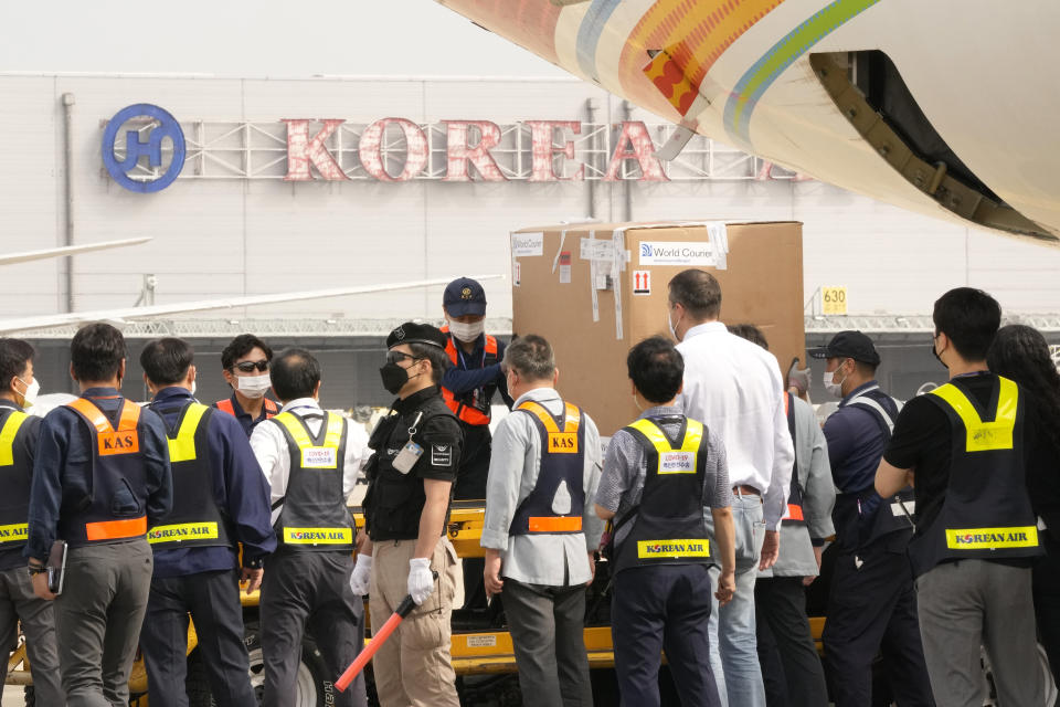 A batch of the Pfizer COVID-19 vaccines sent by Israel is unloaded at the Incheon International Airport in Incheon, South Korea, Wednesday, July 7, 2021. South Korea on Wednesday received 700,000 Pfizer shots from Israel in exchange for a future shipment of vaccines to Israel from September to November, when officials hope South Korea's shortage will have eased. (AP Photo/Ahn Young-joon)