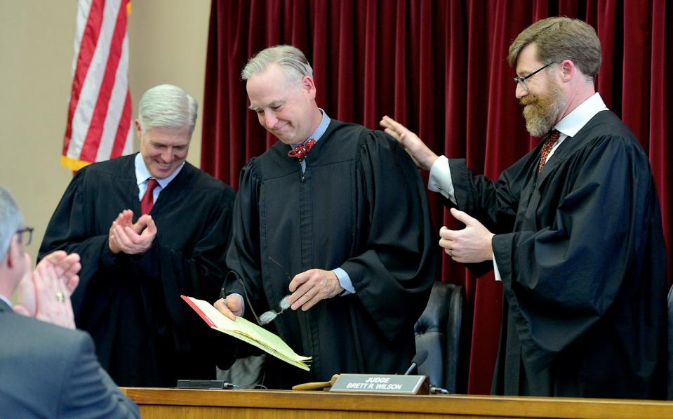 U.S. Supreme Court Justice Neil Gorsuch, left, and Washington County Circuit Court Administrative Judge Brett R. Wilson, right, welcome Joseph S. Michael, center, to the bench after he was sworn in as associate judge of the Circuit Court of Washington County on Friday during a ceremony in the old courthouse in Hagerstown.
